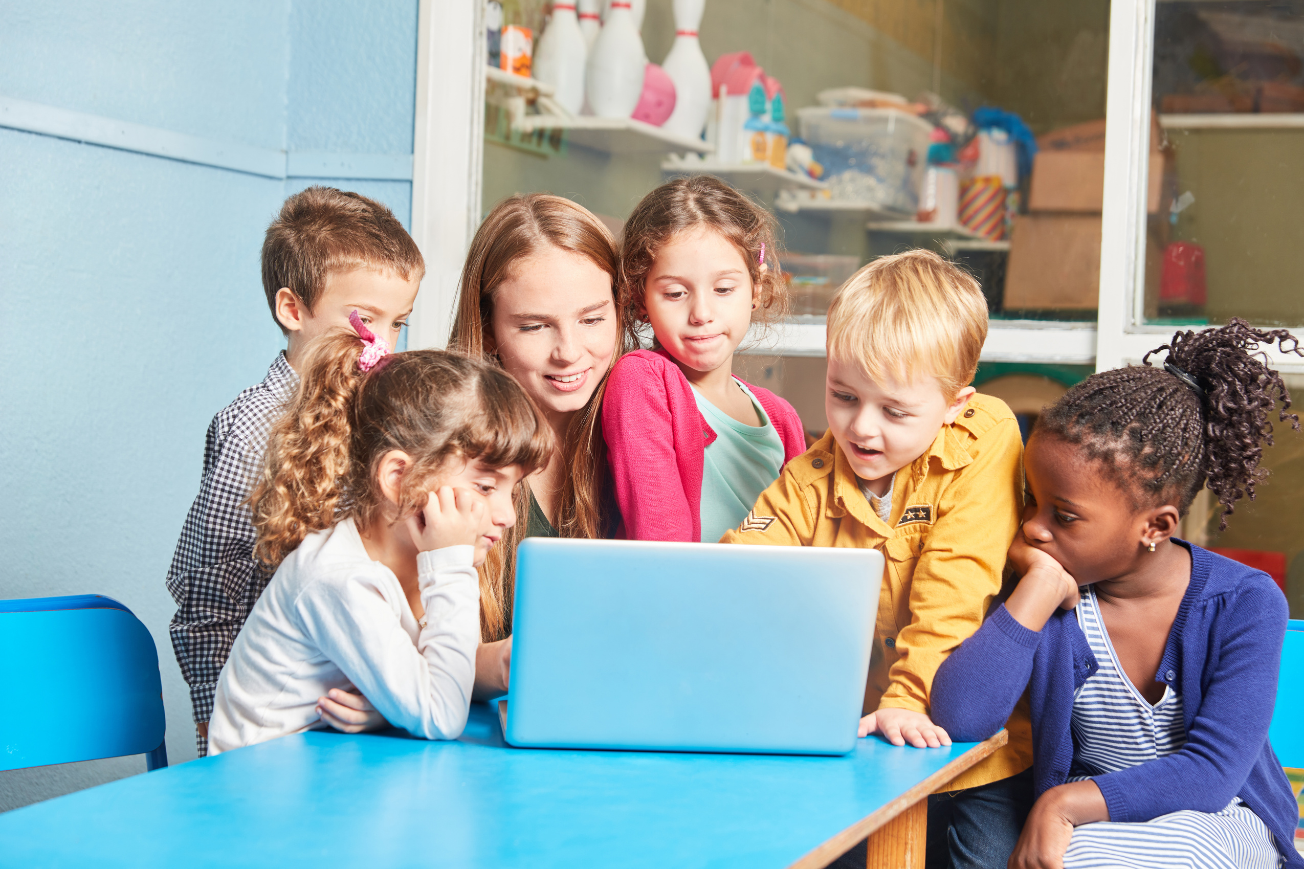 Teacher and Group of Children Learning on Laptop